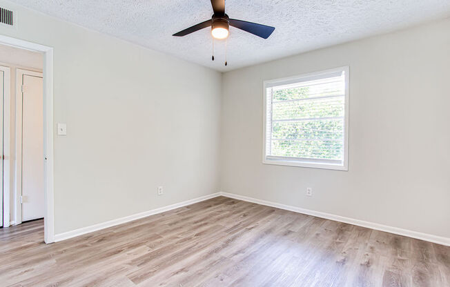 an empty room with a ceiling fan and a window  at The Oasis on Cascade, Atlanta, 30310