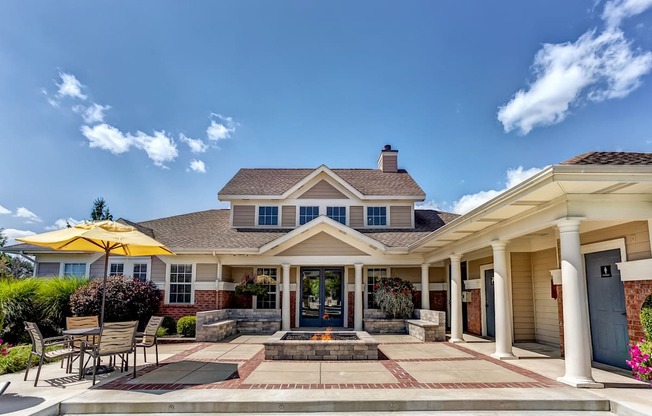 Clubhouse exterior with seating area and fire pit close to Eagle Creek Park and Downtown Indianapolis