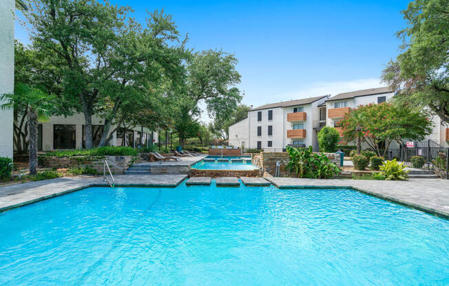 Tides at Esperanza community pool and hot tub with apartment buildings in the background