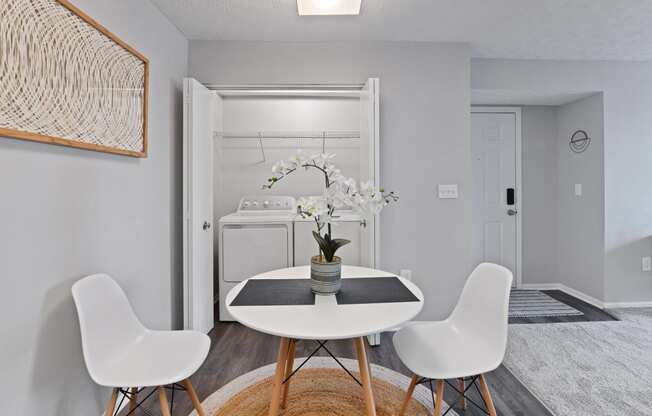 a dining room with a table and chairs and a laundry room