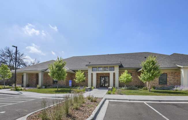 a large brick building with a parking lot and a driveway