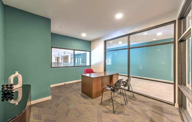 a conference room with large windows and a desk and chairs at Pinnacle Apartments, Jacksonville, 32256