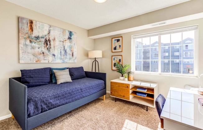 a living room with a couch and a desk