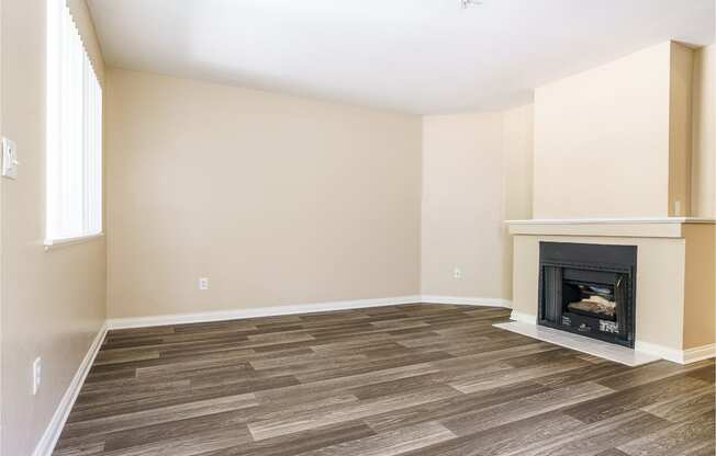 renovated floor plan with plank style flooring and fireplace