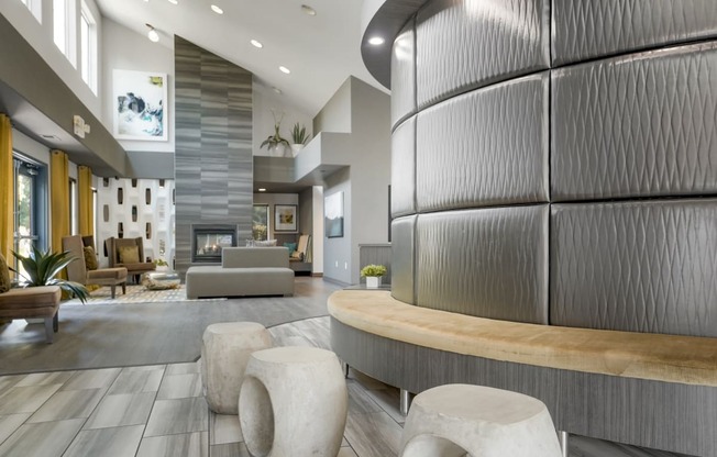 the lobby of a community center with a fireplace and couches