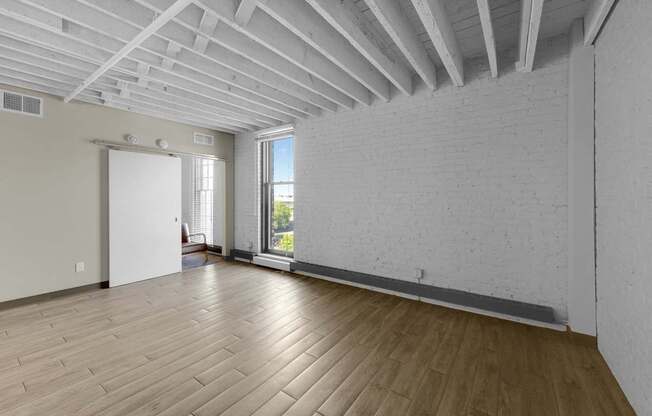 A room with wooden floors and white walls.
