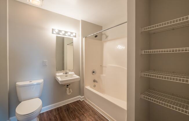 a bathroom with a toilet and a tub and a sink at Crogman School Lofts, Georgia, 30315