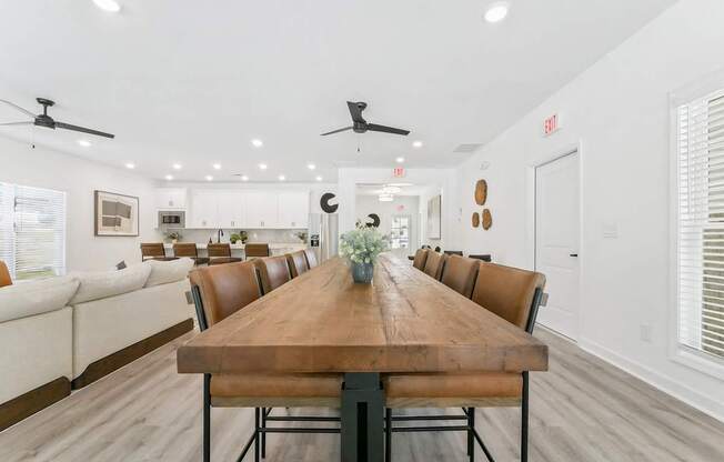a dining room with a wooden table and leather chairs