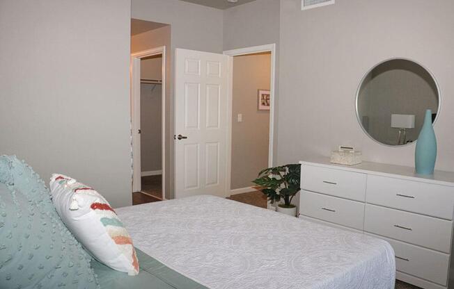 a bedroom with a bed and a mirror