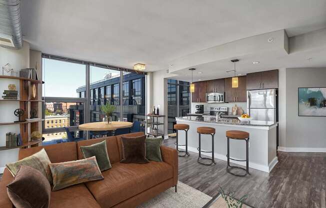 a living room with a couch and a kitchen with a bar