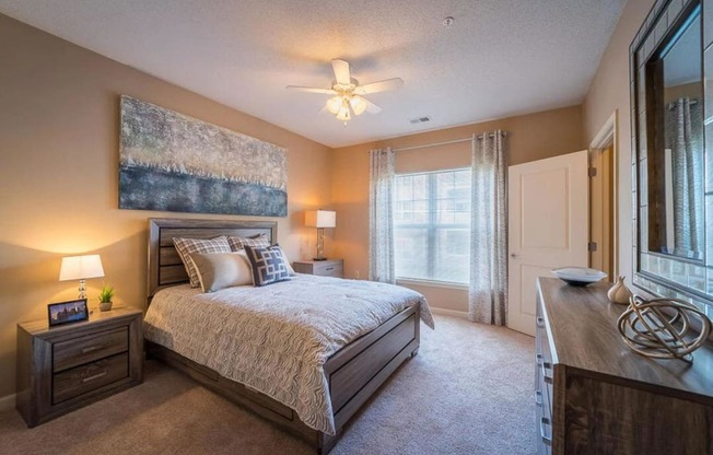 a bedroom with a bed and a ceiling fan