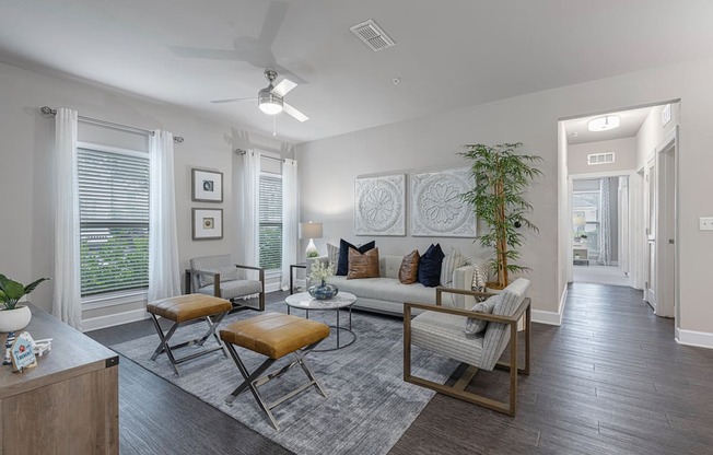 an open living room with a couch and chairs