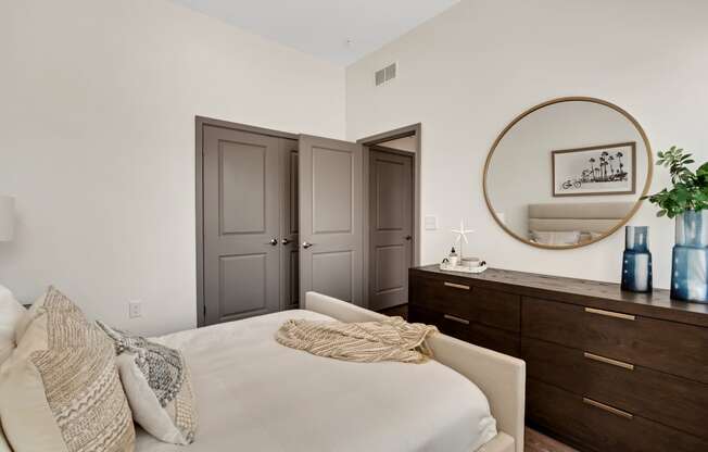 a bedroom with white walls and dark wood furniture  at The Sophia, Venice, FL, 34275