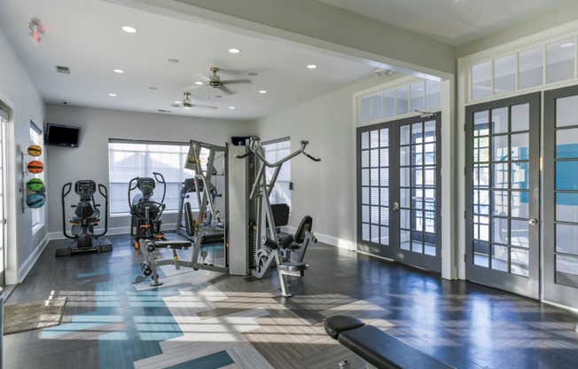 a gym with weights and cardio equipment in a home at The Shallowford, Chattanooga