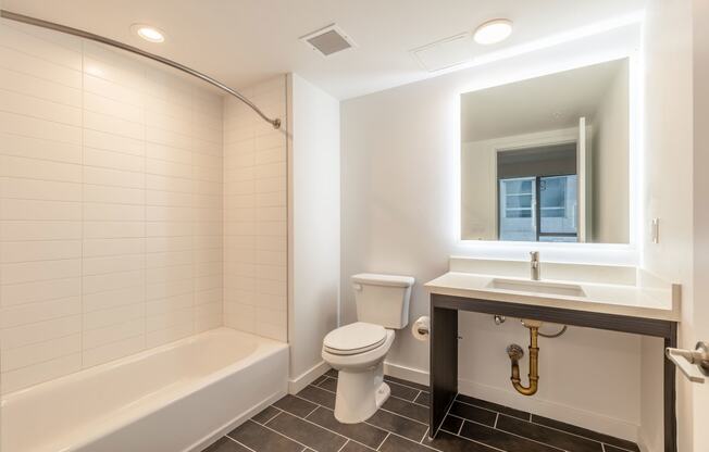 a bathroom with a toilet sink and a bath tub