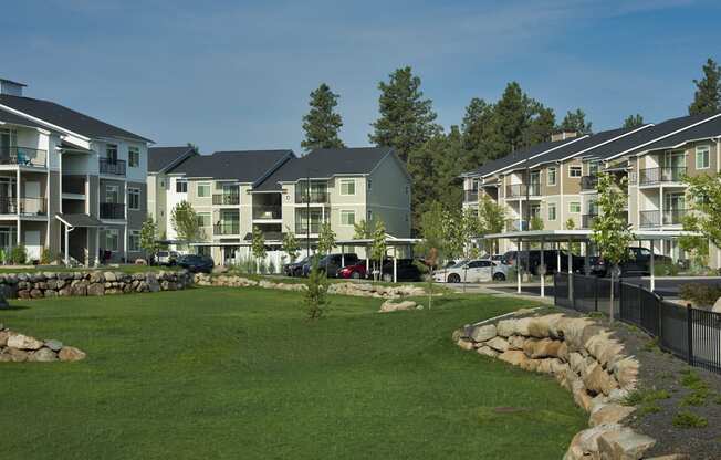 River House Apartments Spacious Grass Fields and Exterior Buildings