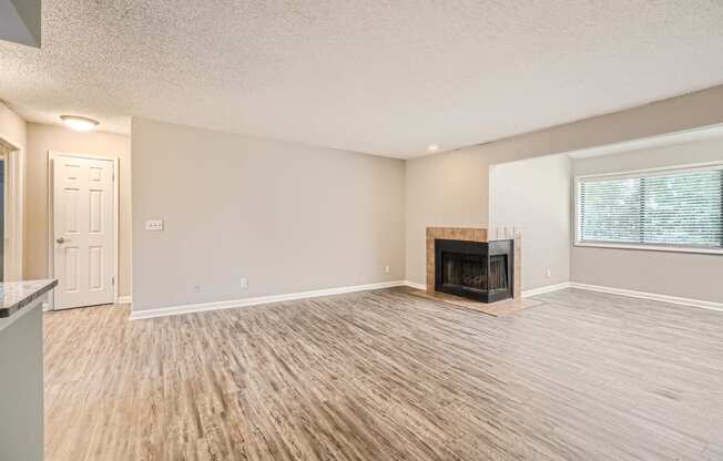 a living room with a fireplace and wooden floors