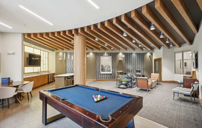 a clubhouse with a pool table and a living room