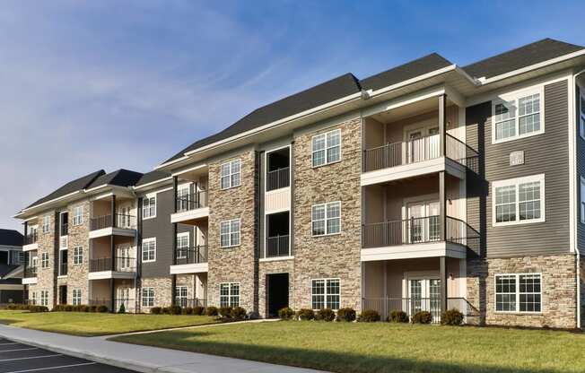 an exterior view of an apartment building on a sunny day