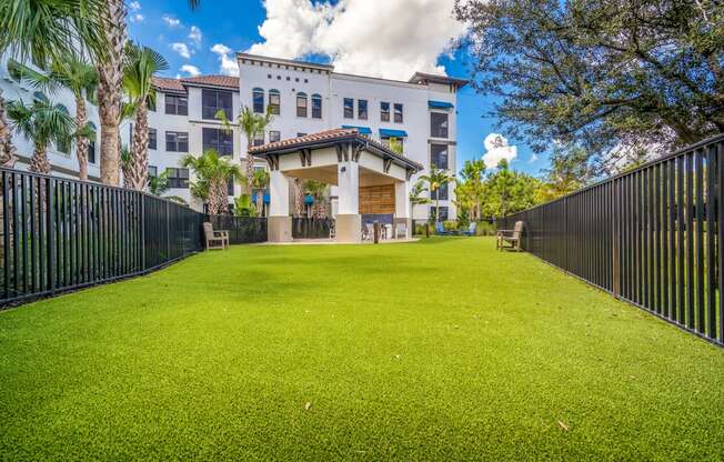 green lawn enclosed by black fence at Magnolia Square, Naples, FL