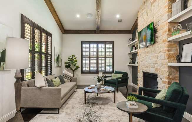 a living room with couches and chairs and a fireplace