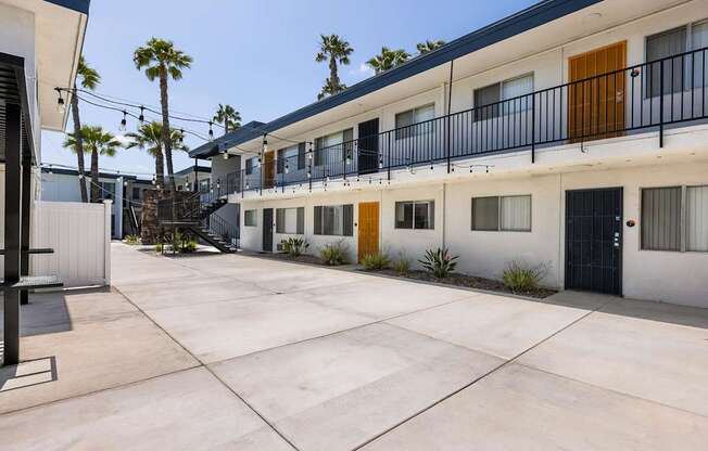 A sunny day at a modern apartment complex with a courtyard.