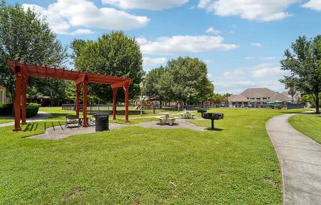 A park with a red structure and a pathway.