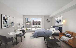 A modern bedroom with a large bed, a couch, a table, and a view of the city.