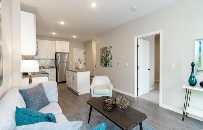 Living room with couch and coffee table with view into the island kitchen