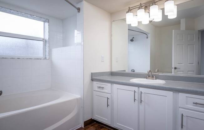 Village at Main Street | 2x2 Bedroom One Bathroom with White Cabinetry and Large Mirror