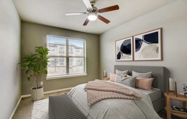 a bedroom with a large bed and a ceiling fan