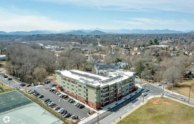 an aerial view of a building and a parking lot