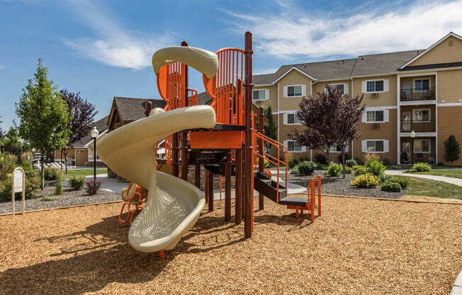 a playground with a slide at Quail Springs Apartments