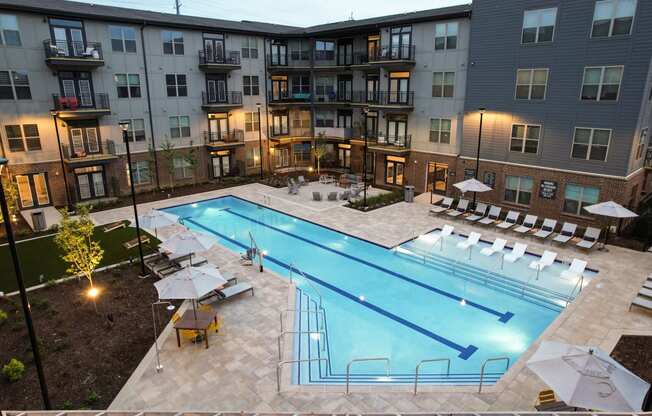 an aerial view of an apartment building with a swimming pool