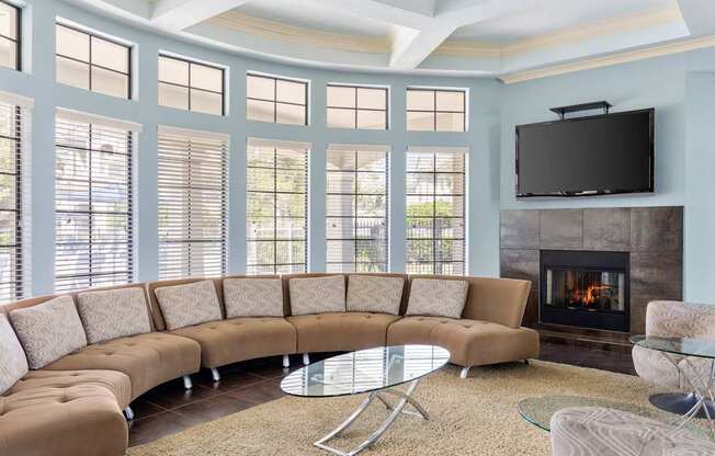 A living room with a fireplace and a television.