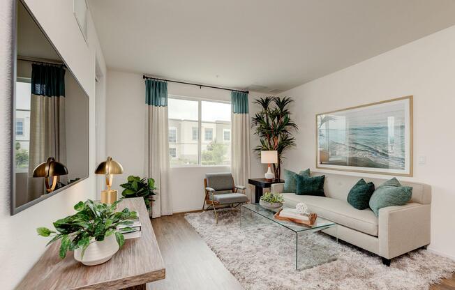 a living room filled with furniture and a large window