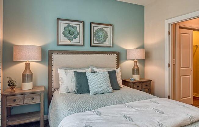 a bedroom with a bed and two night stands with lamps  at Sapphire at Centerpointe, Midlothian, Virginia