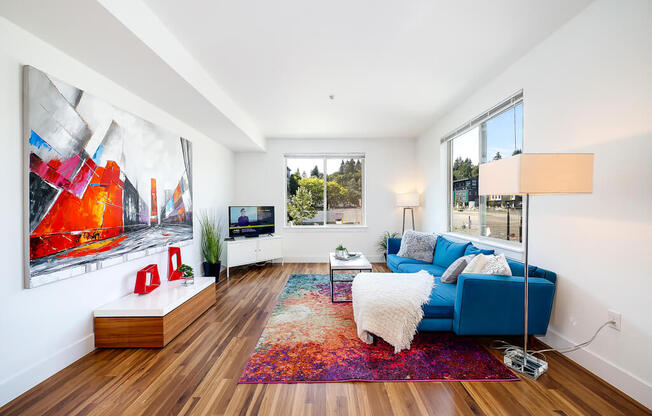 a living room with a blue couch and a rug