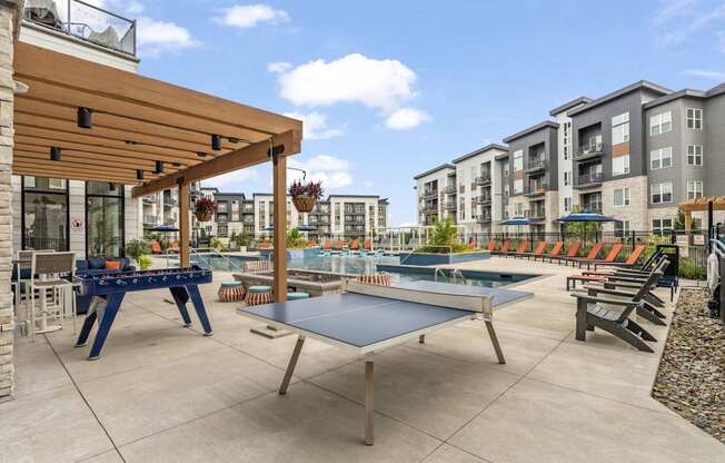 furnished patio with ping pong tables and amenities at the addison at collin
