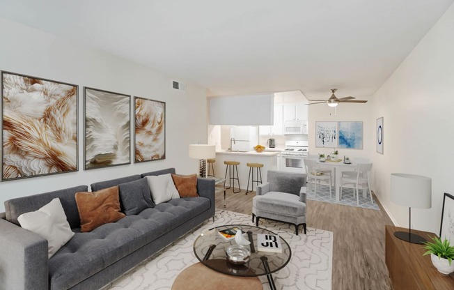 a living room with a couch and a coffee table and a kitchen with a table