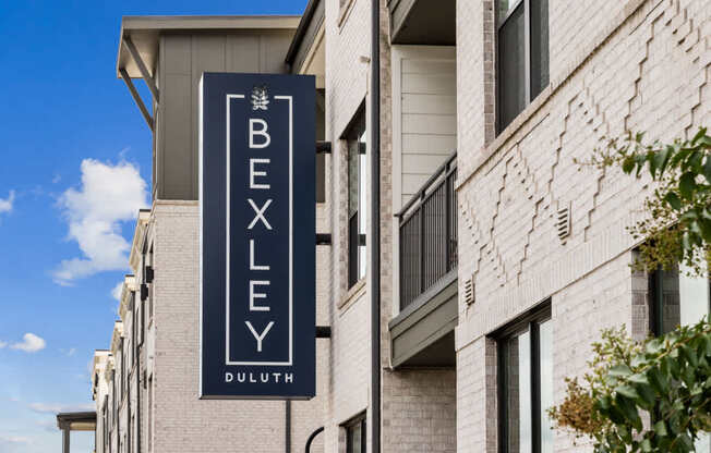 A sign for Bexley Duluth is displayed on a building.