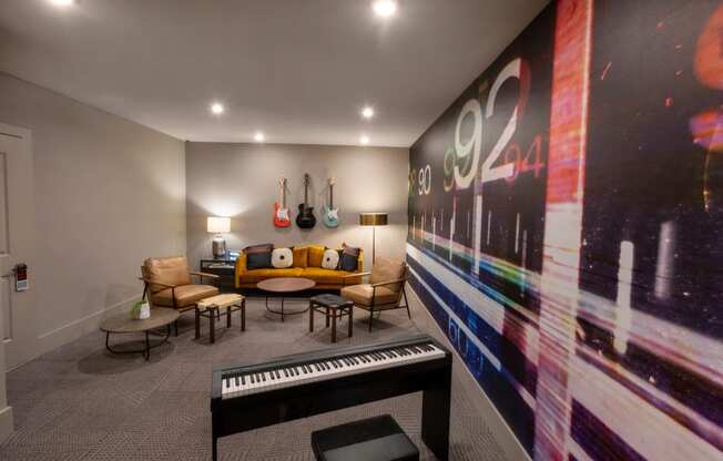 a living room with a piano and a large wall mural of a music album