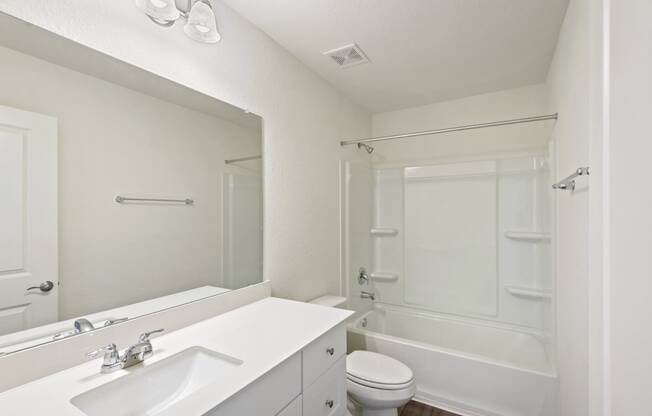 a bathroom with a bathtub and a sink