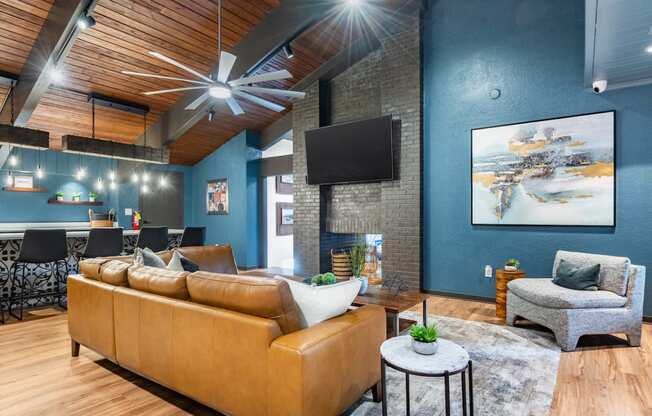 a living room with blue walls and a couch and a tv