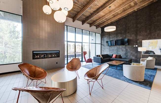 a living room with chairs and couches and a fireplace at Ashford Belmar Apartments, Colorado, 80226