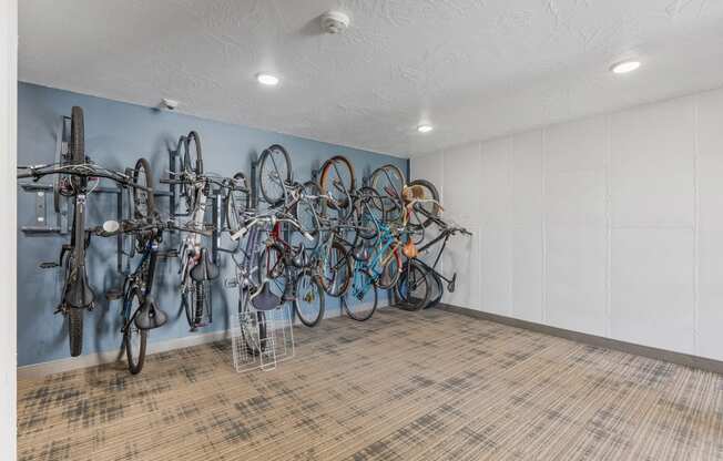 a room with many bikes hanging on the wall