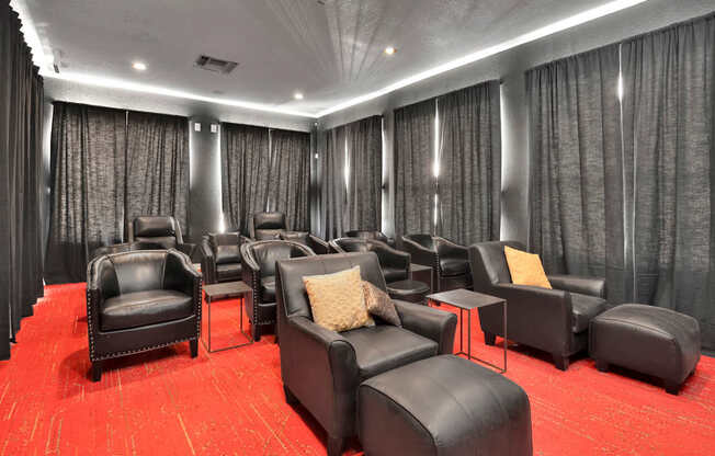a large screening room with leather chairs and curtains
