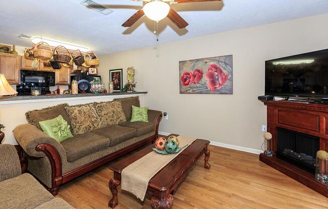 a living room filled with furniture and a flat screen tv