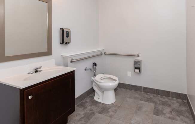 an accessible bathroom with a toilet and a sink