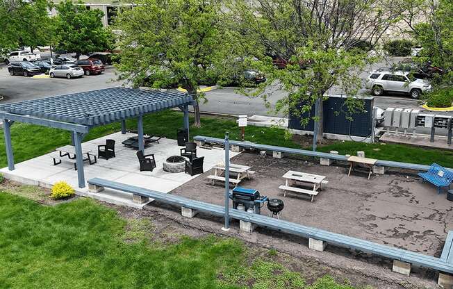 A covered outdoor seating area with tables and chairs.